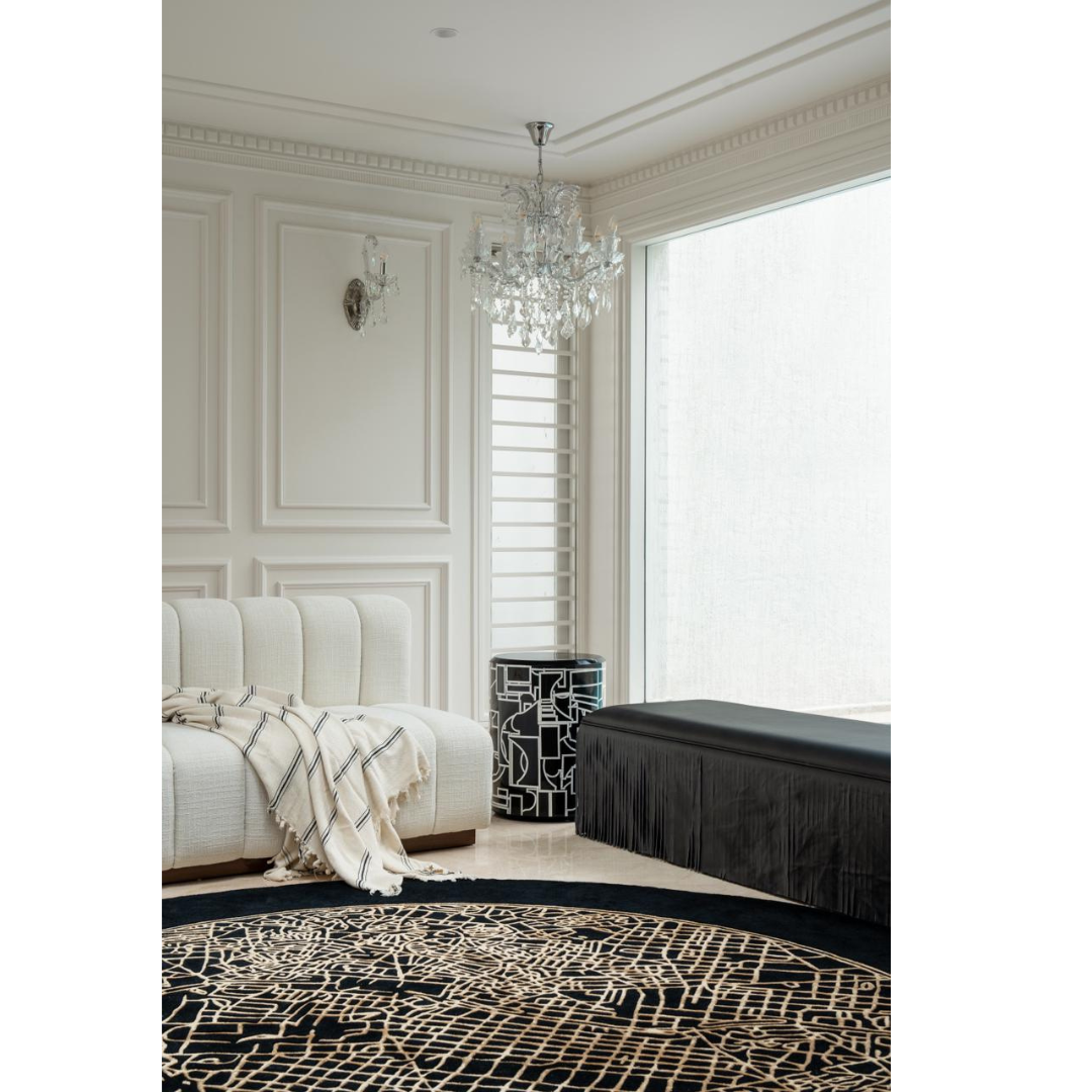 Madrid Rug handcrafted round black and beige abstract map rug in elegant living room with cream sofa