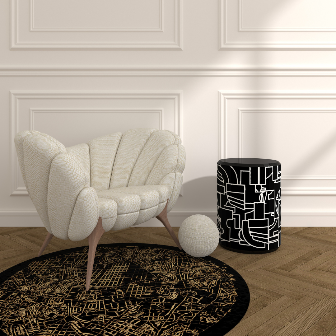 Madrid Rug handcrafted black round rug with gold map pattern under cream shell chair in modern living room