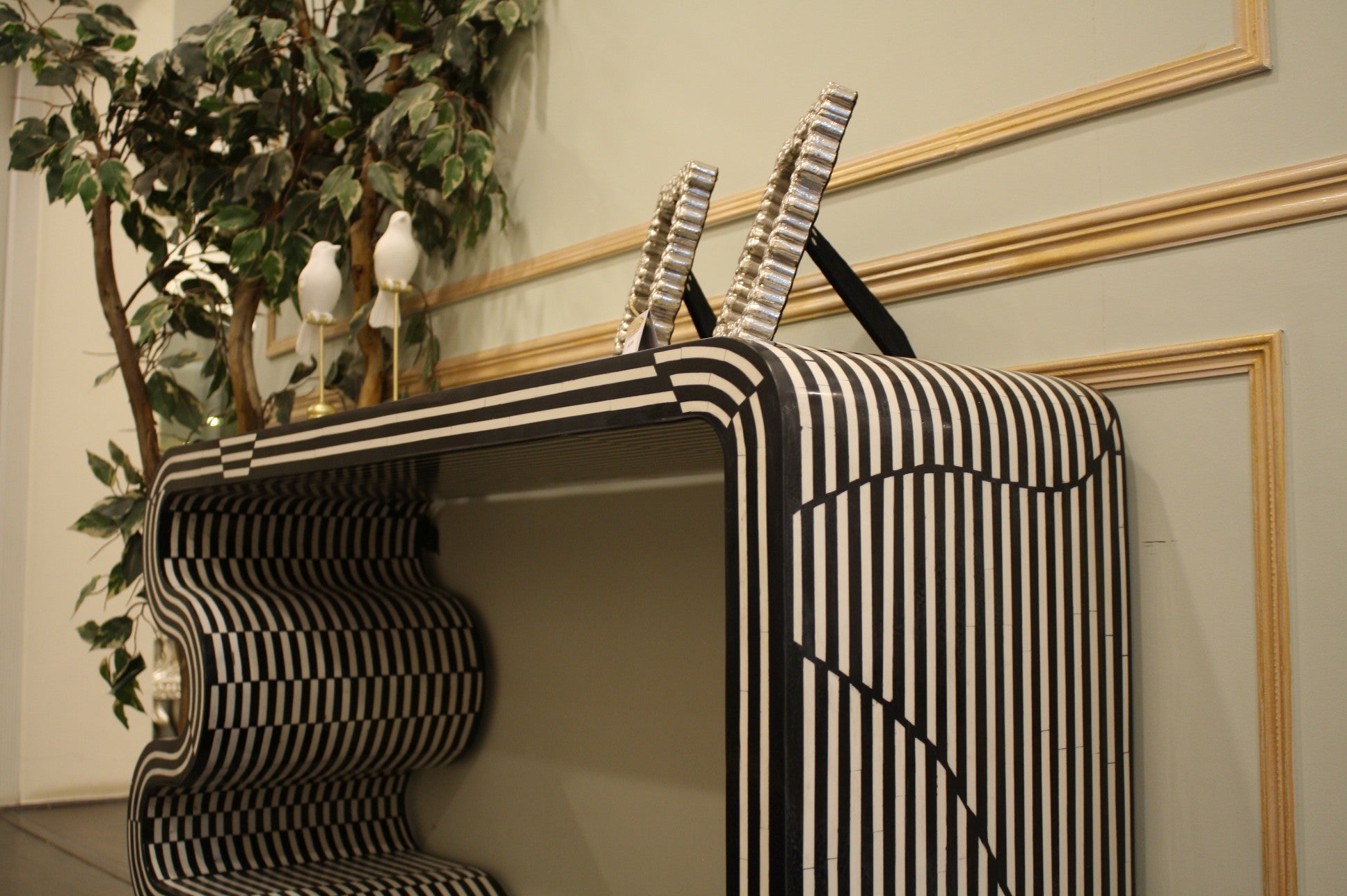 Monochrome twist black and white striped table with curved edges and decorative handles