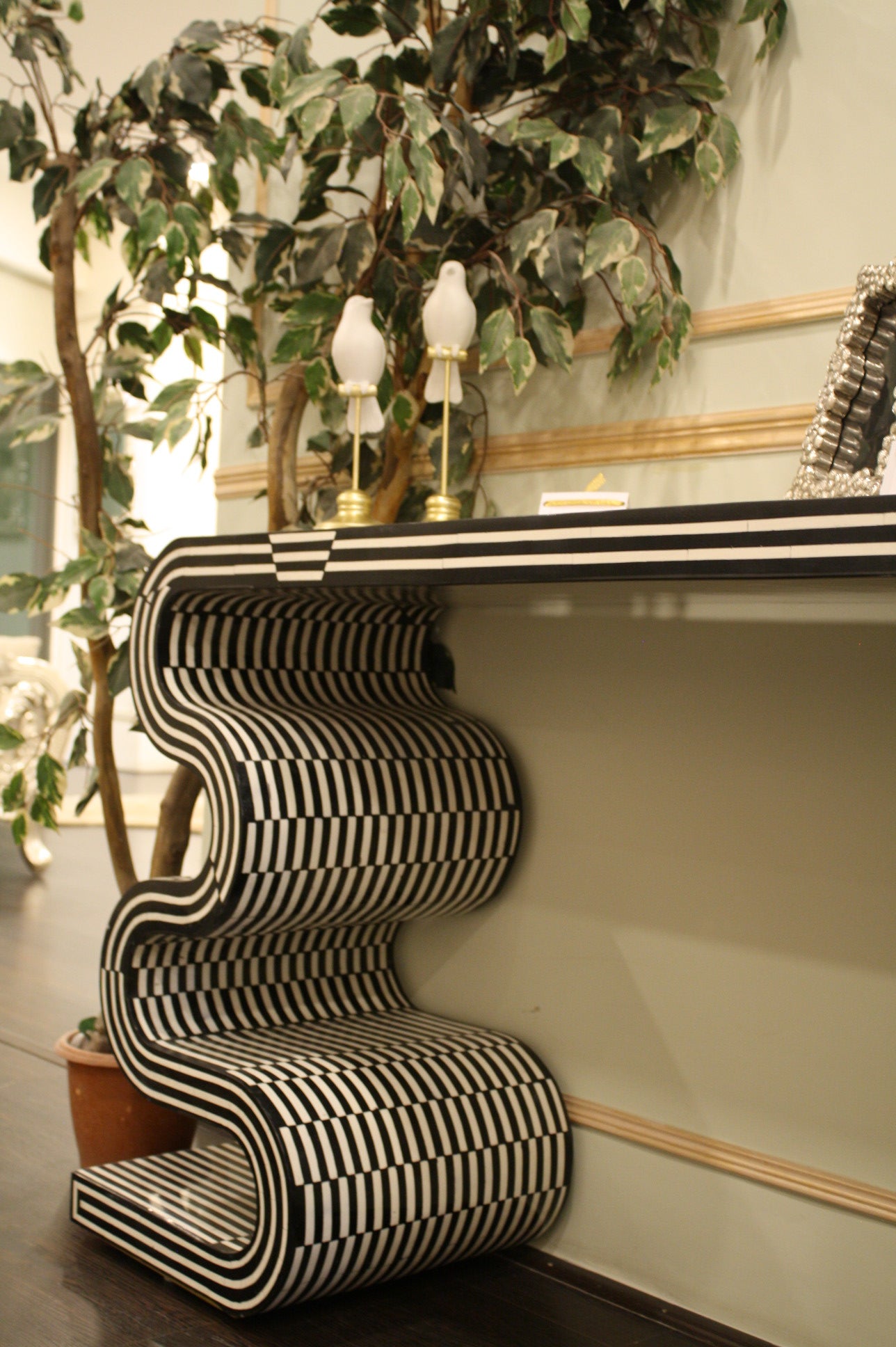Monochrome twist table with black and white striped wavy design in modern interior