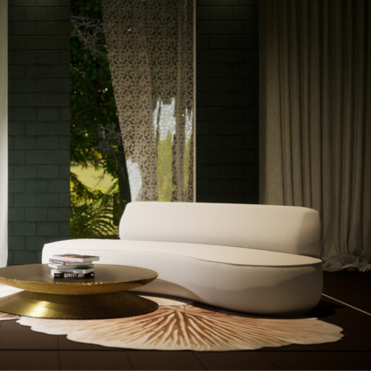 Modern curved ivory sofa in a stylish living room with gold coffee table and patterned rug
