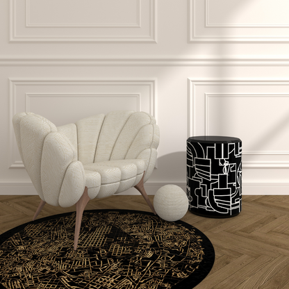 Madrid Rug handcrafted black round rug with gold map pattern under cream shell chair in modern living room
