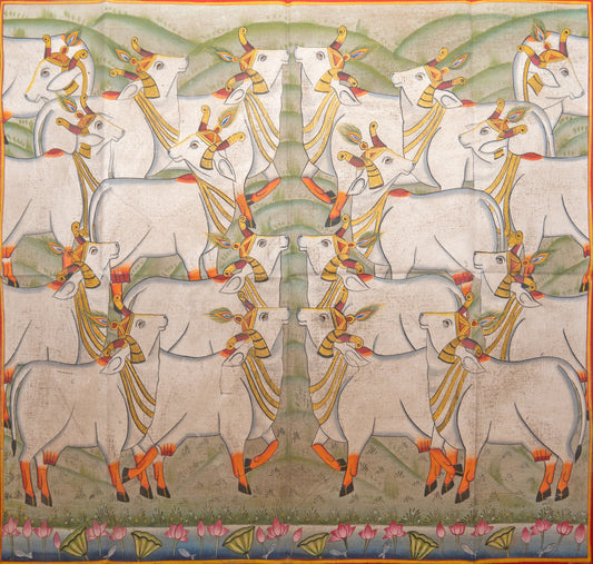The summer meadow Pichwai Painting showing symmetrical white cows in a pastoral scene with lotus border and green hills
